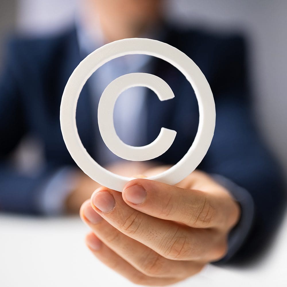 Person holding copyright symbol