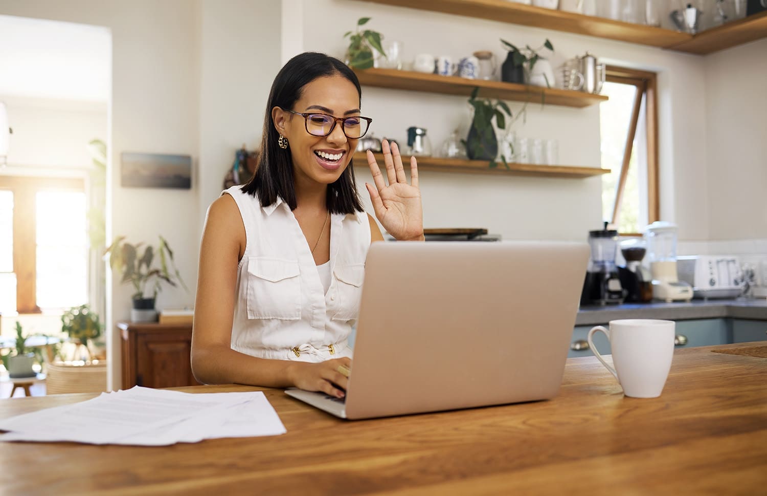 Woman on a laptop participating in a video conference call to collaborate and plan.