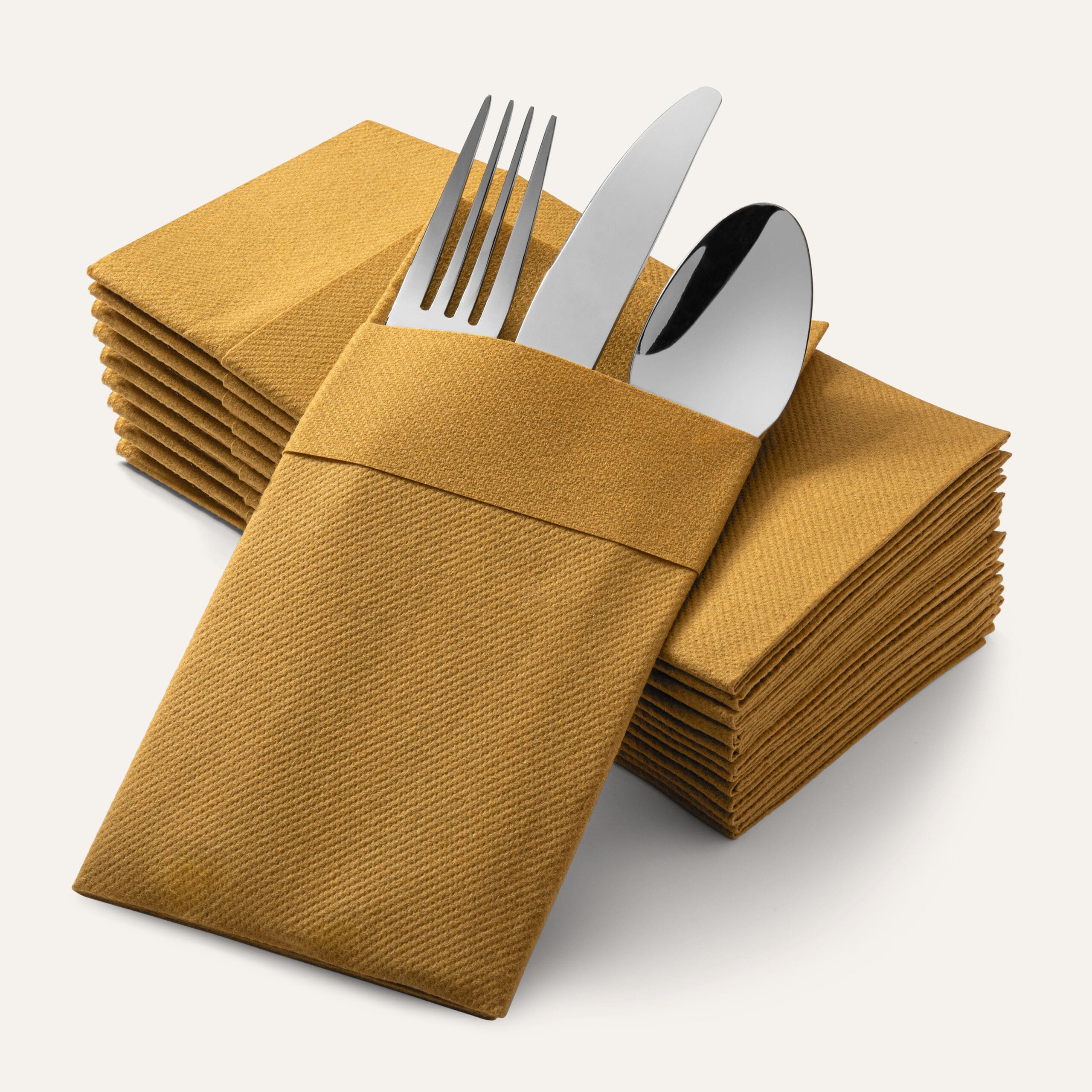 A stack of paper napkins with cutlery on a tan background