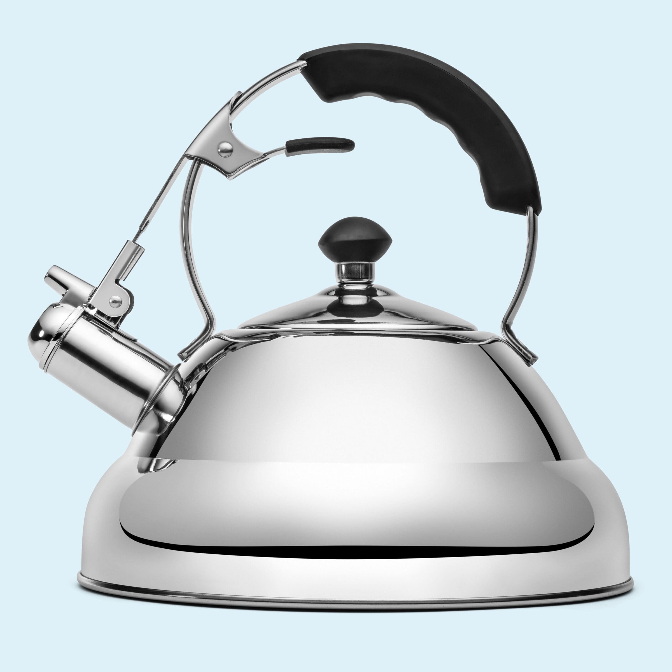 A shiny chrome tea kettle on a blue background